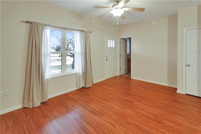 unfurnished room featuring ceiling fan, plenty of natural light, and light wood-type flooring