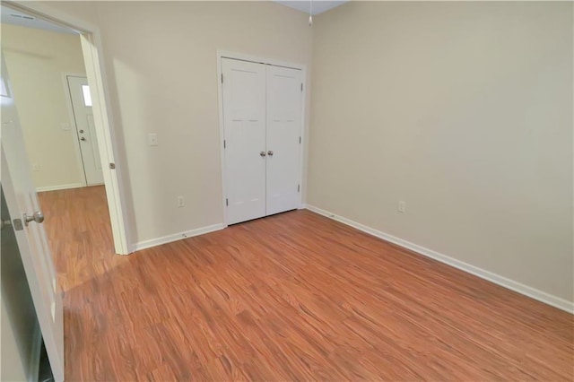 unfurnished bedroom featuring a closet and light hardwood / wood-style floors