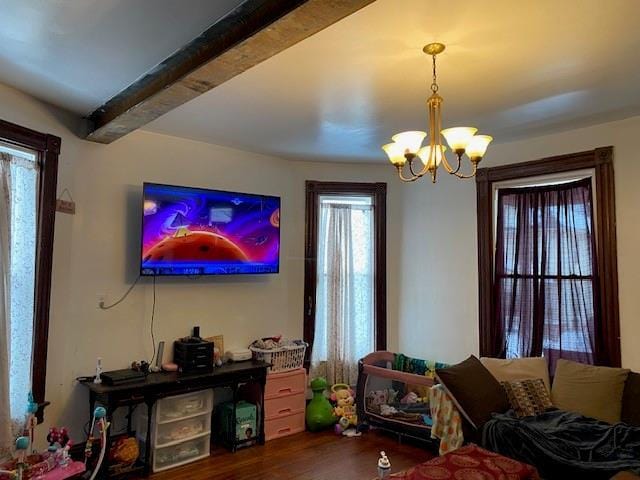 living room featuring hardwood / wood-style flooring, beam ceiling, and a chandelier