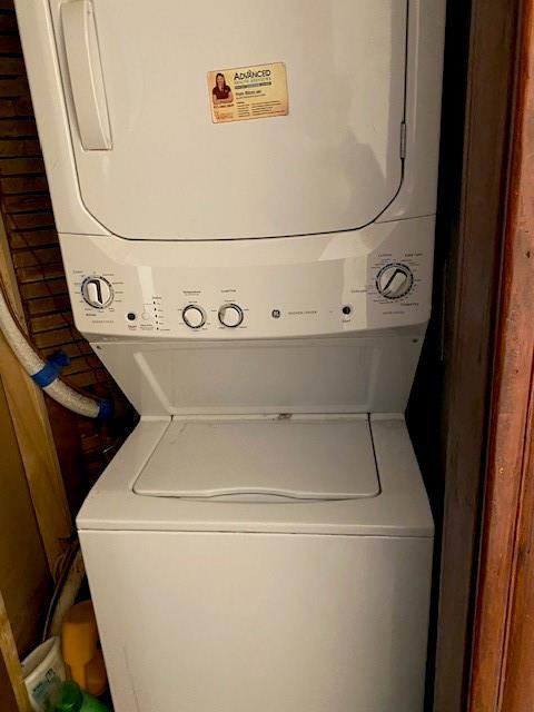 laundry room featuring stacked washing maching and dryer