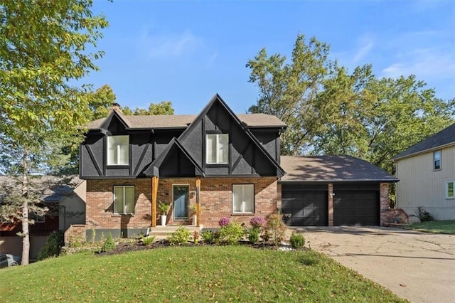 tudor home featuring a front yard and a garage