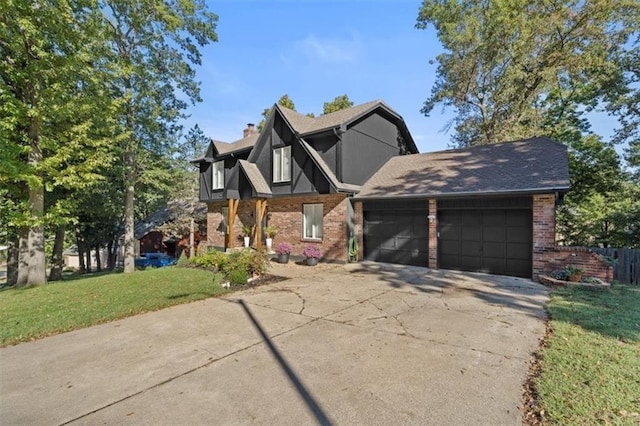 tudor home with a garage and a front lawn