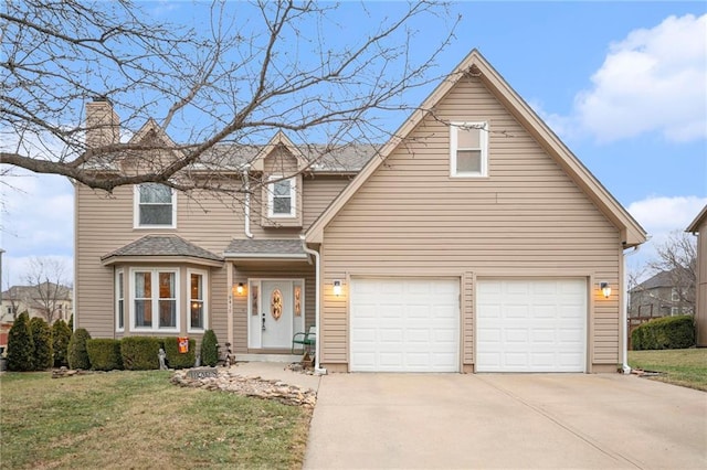 view of property featuring a garage and a front lawn