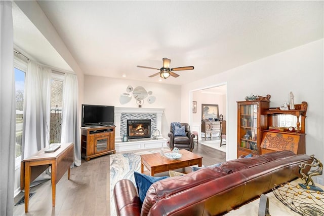 living room with wood-type flooring and ceiling fan