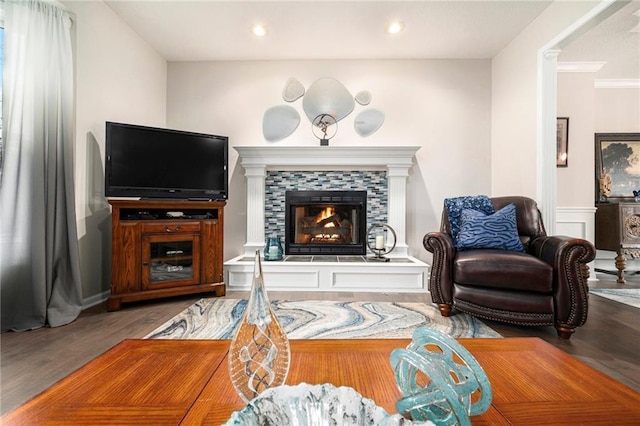 interior space featuring a tiled fireplace and wood-type flooring