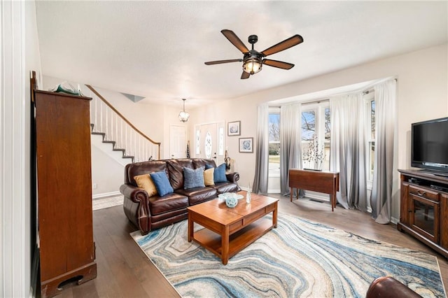 living room with wood-type flooring and ceiling fan