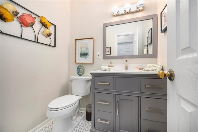 bathroom featuring vanity, tile patterned flooring, and toilet