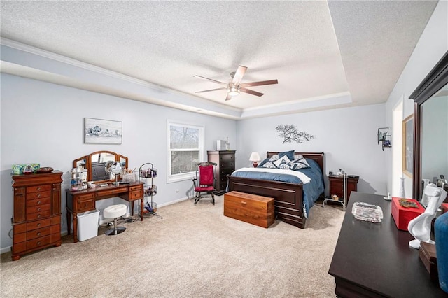 bedroom featuring ceiling fan, a tray ceiling, light carpet, and a textured ceiling