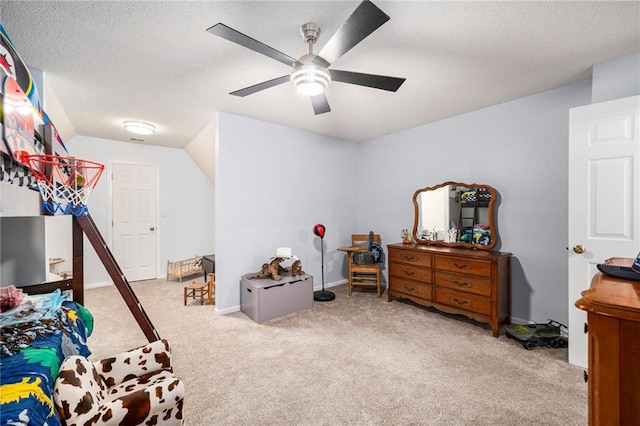 bedroom featuring light carpet, ceiling fan, lofted ceiling, and a textured ceiling