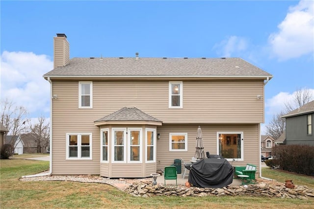 back of property with a patio and a lawn