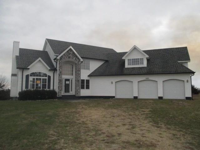 view of front facade with a front lawn and a garage