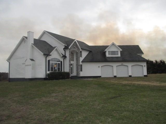 view of front of property with a front lawn and a garage