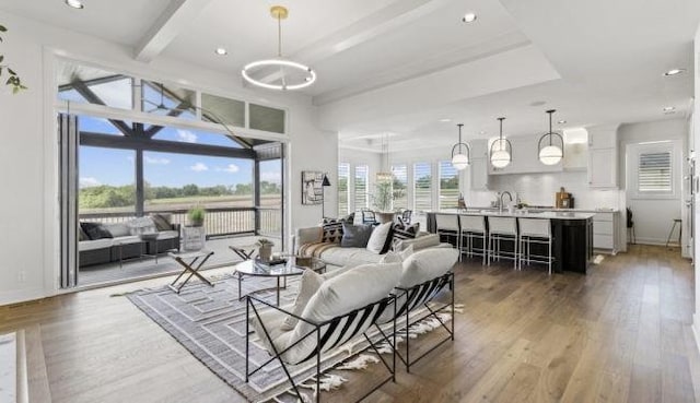 16905 Parkhill St, Overland Park, KS 66221 - living area with light wood-style flooring, recessed lighting, and beam ceiling