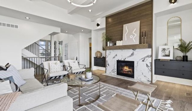 16905 Parkhill St, Overland Park, KS 66221 - living room with a fireplace, wood finished floors, recessed lighting, and beamed ceiling