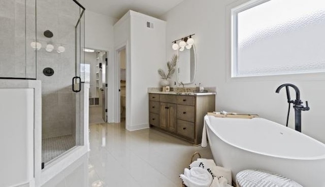 16905 Parkhill St, Overland Park, KS 66221 - full bathroom featuring vanity, a shower stall, a freestanding tub, and plenty of natural light