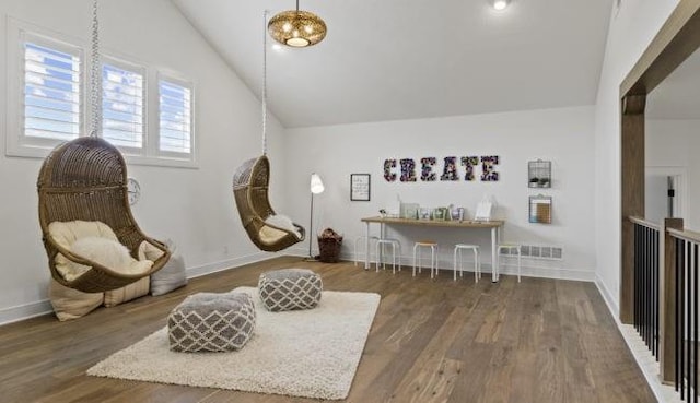 16905 Parkhill St, Overland Park, KS 66221 - living area featuring vaulted ceiling and wood finished floors