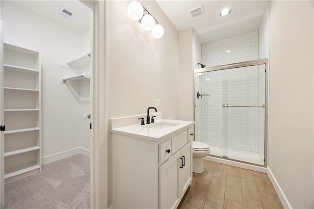 full bathroom with a shower stall, a spacious closet, toilet, and visible vents