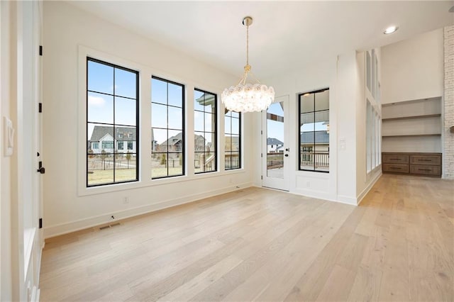 interior space featuring a chandelier and light hardwood / wood-style floors