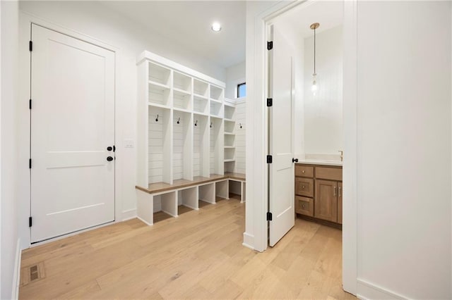 mudroom with light hardwood / wood-style flooring