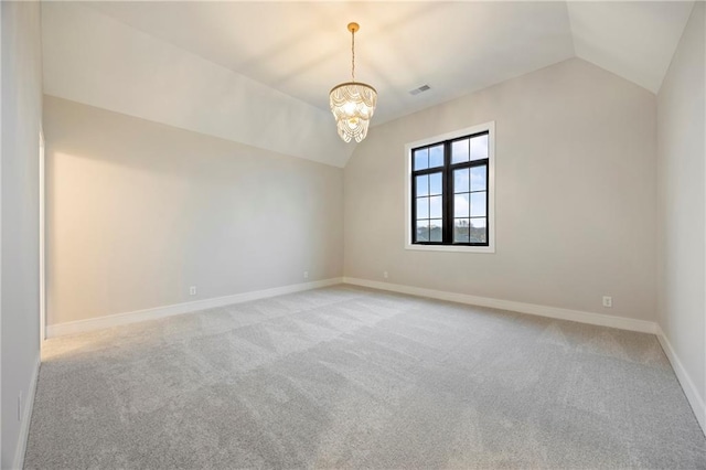 spare room with light carpet, visible vents, baseboards, and vaulted ceiling