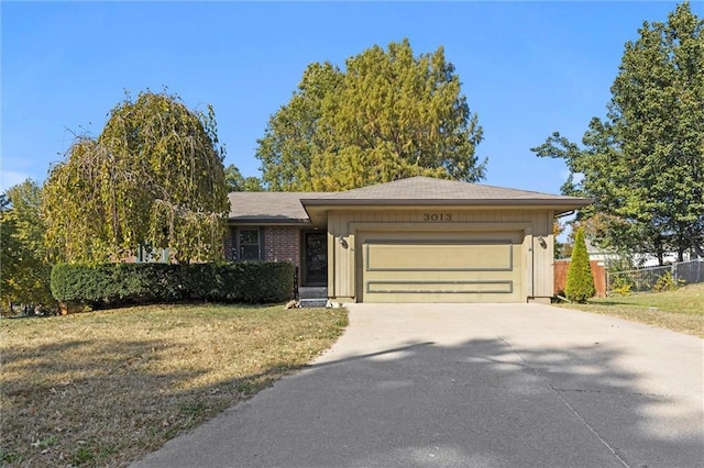 single story home with a front yard and a garage