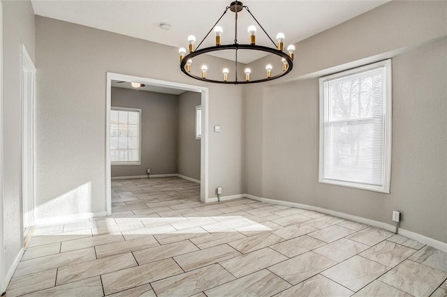 empty room featuring an inviting chandelier