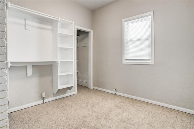 walk in closet featuring light carpet