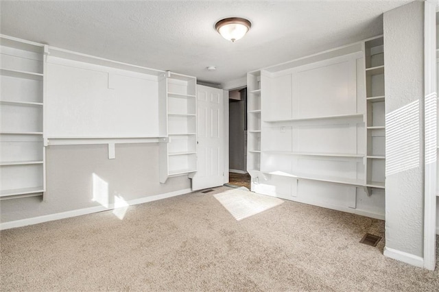 unfurnished bedroom with carpet flooring and a textured ceiling