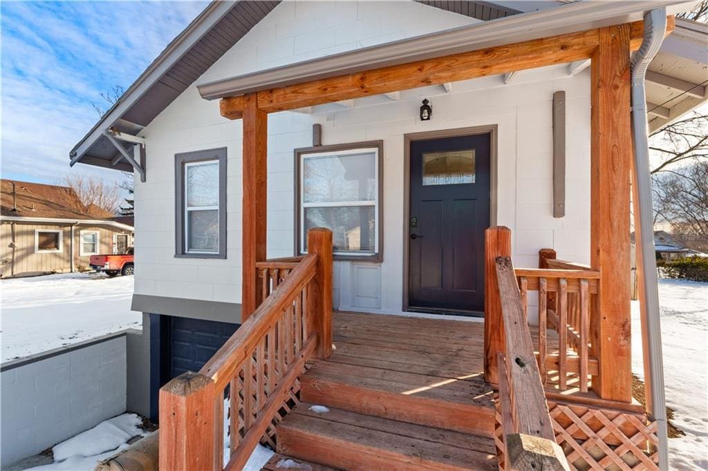 view of snow covered property entrance