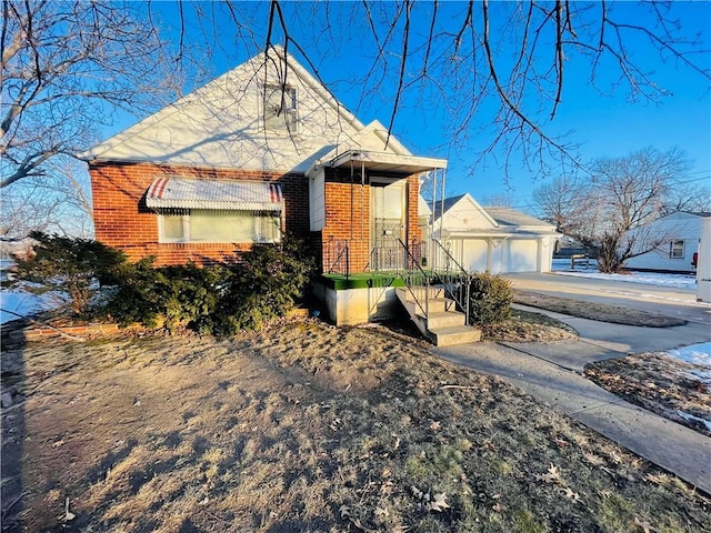 view of front facade featuring an outbuilding and a garage