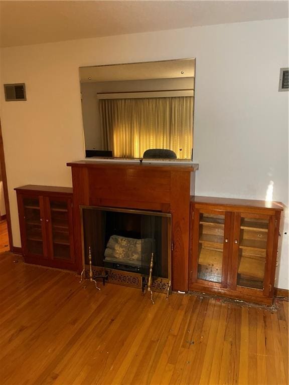 unfurnished living room featuring hardwood / wood-style flooring