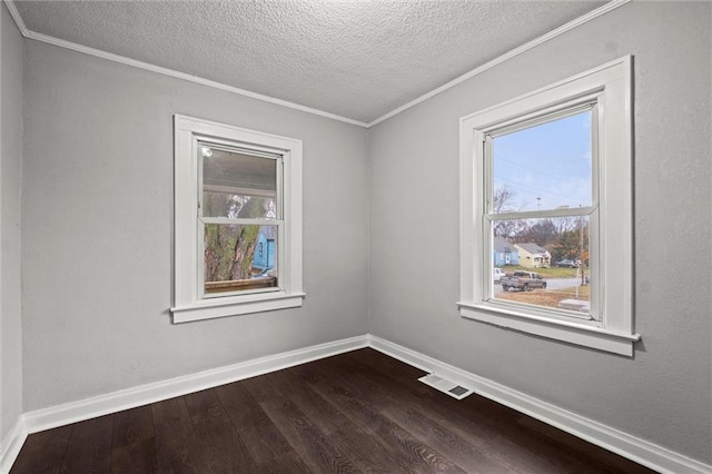 spare room with hardwood / wood-style flooring, ornamental molding, and a textured ceiling