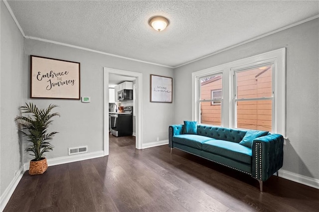 sitting room featuring hardwood / wood-style floors, a textured ceiling, and ornamental molding