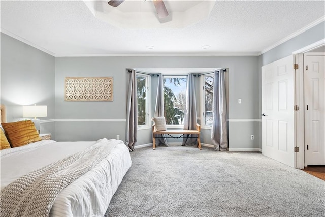 bedroom featuring carpet, ceiling fan, crown molding, and a textured ceiling