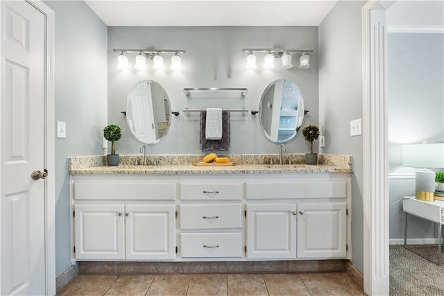 bathroom with tile patterned floors and vanity