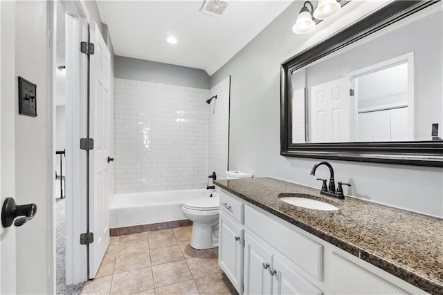 full bathroom featuring tile patterned flooring, vanity, toilet, and tiled shower / bath combo