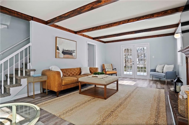 living room featuring beam ceiling, dark wood-type flooring, french doors, and a fireplace