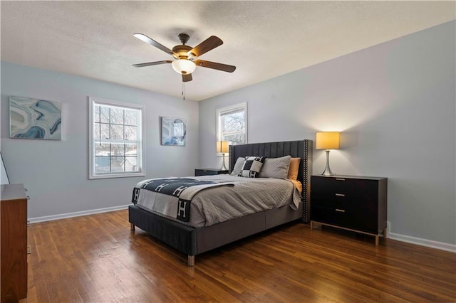 bedroom with ceiling fan and dark wood-type flooring