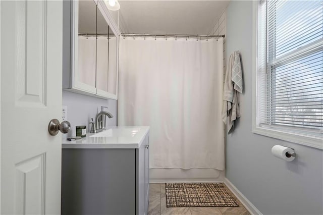 bathroom featuring shower / bathtub combination with curtain, tile patterned floors, and vanity