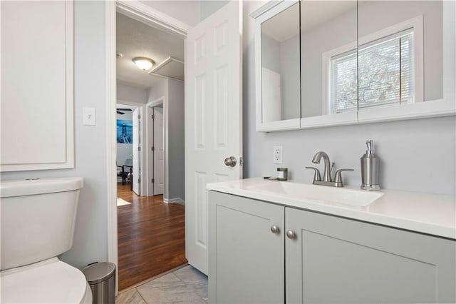 bathroom featuring toilet and vanity