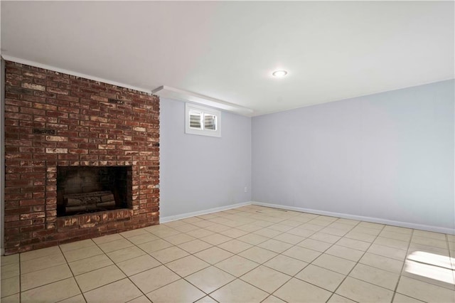 basement featuring a brick fireplace and light tile patterned floors