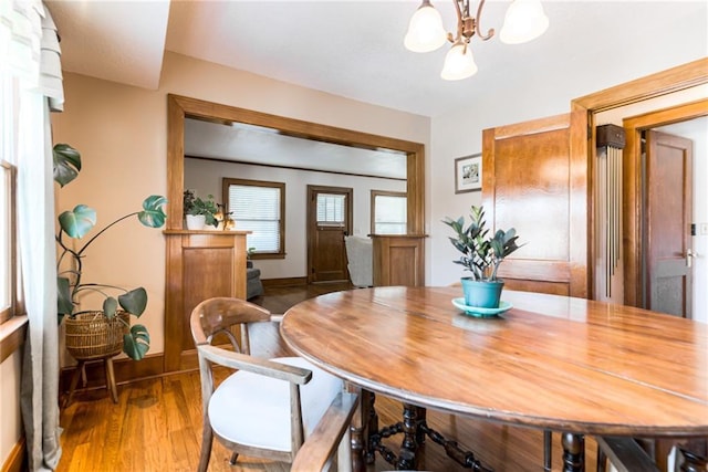 dining room featuring hardwood / wood-style floors and a chandelier