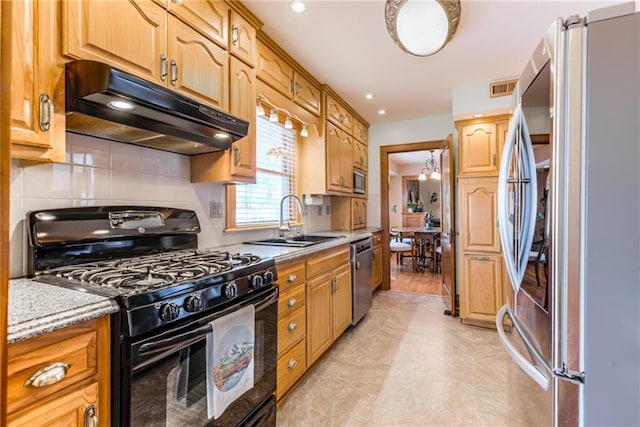 kitchen with stainless steel appliances, sink, and decorative backsplash