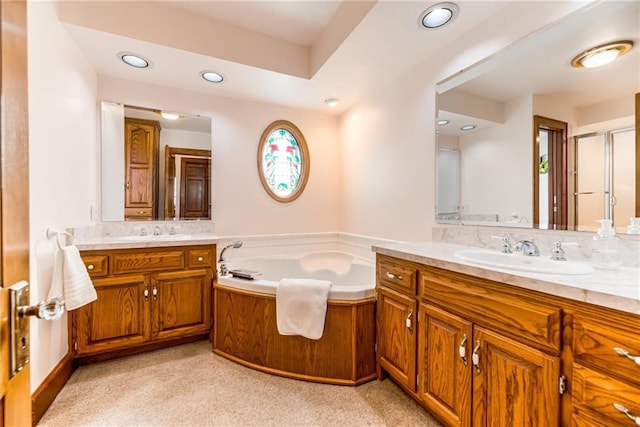 bathroom featuring vanity and shower with separate bathtub