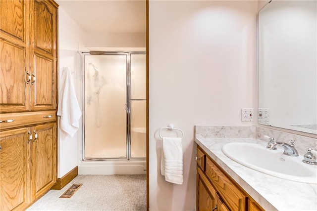 bathroom with vanity and a shower with door