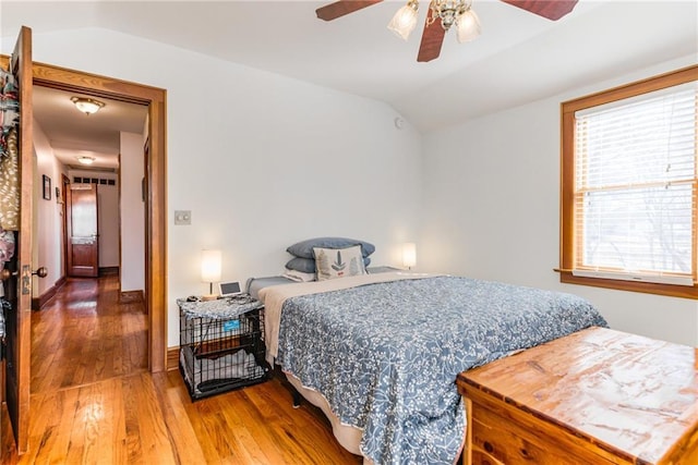 bedroom with hardwood / wood-style flooring, ceiling fan, and lofted ceiling