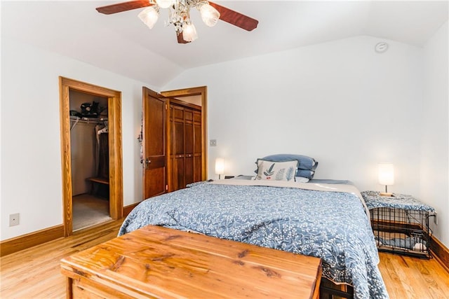 bedroom featuring lofted ceiling, ceiling fan, hardwood / wood-style floors, a spacious closet, and a closet