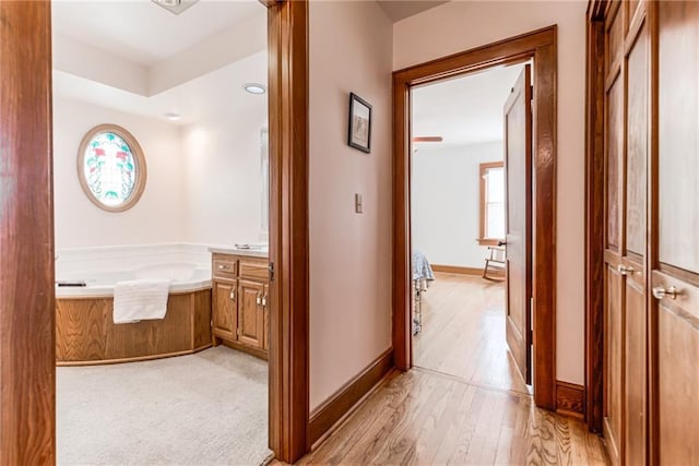 corridor with light hardwood / wood-style flooring