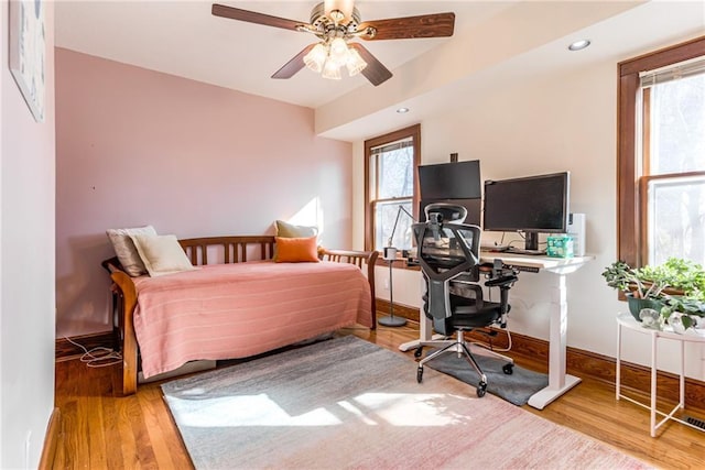 bedroom with light hardwood / wood-style floors and ceiling fan