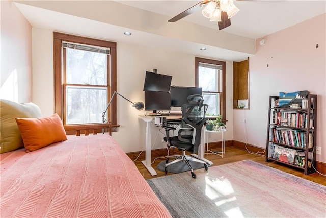 bedroom with wood-type flooring and ceiling fan